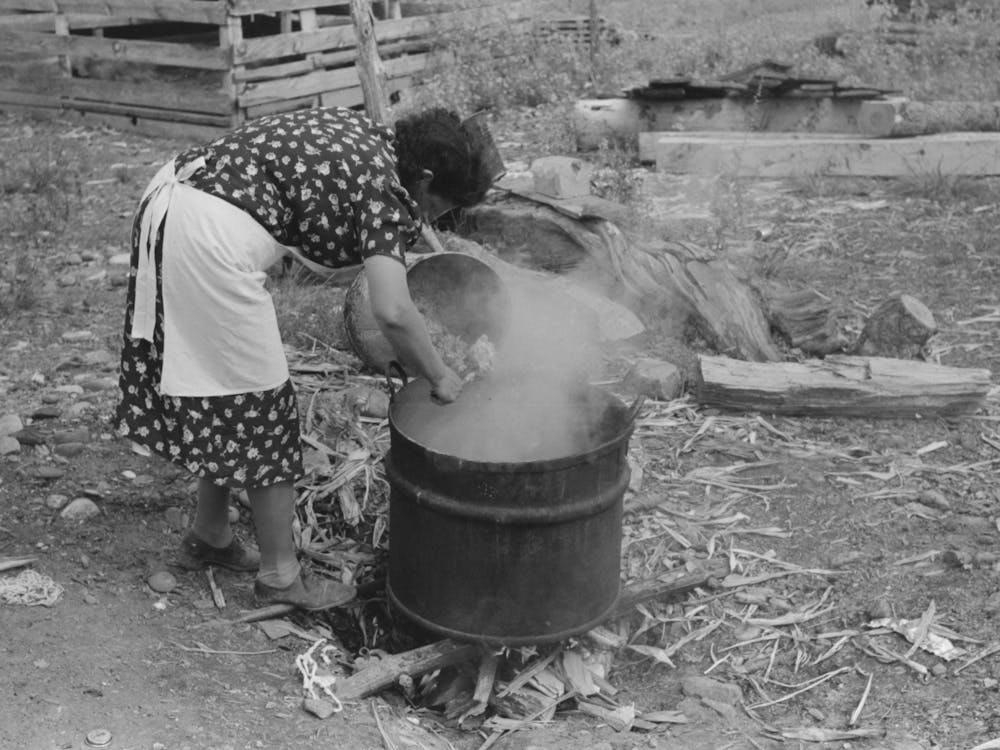 Untitled Photo, Possibly Related To Spanish American Fsa (Farm Security Administration) Client Emptying Pail Of