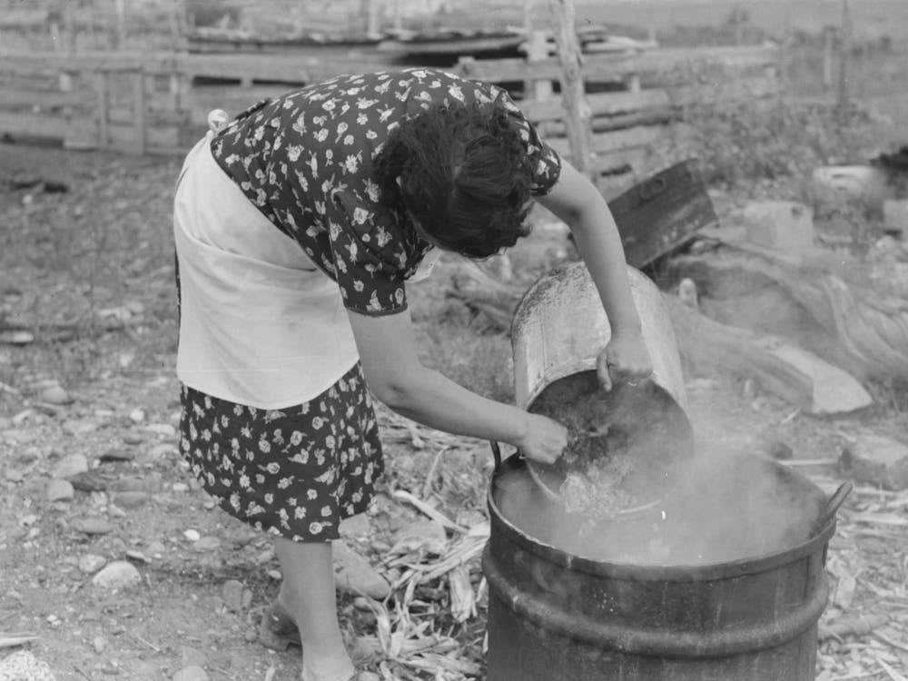 Untitled Photo, Possibly Related To Spanish American Fsa (Farm Security Administration) Client Emptying Pail Of 1