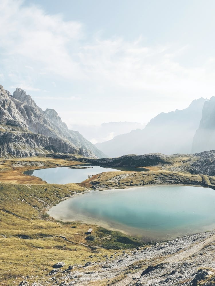 Dolomites, Italy I Alps mountain scenery photography and crystal clear water lakes in Tre Cime di Lavaredo in the morning sunlight in a rustic authentic wilderness with a pastel italian aesthetic