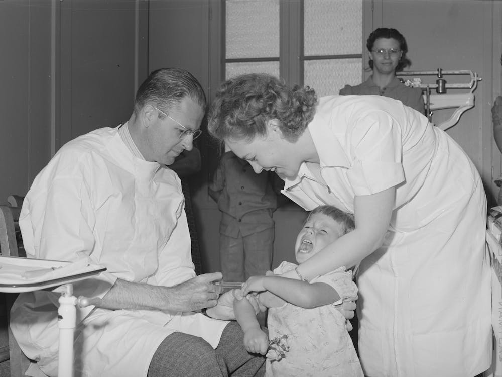Doctor And Nurse Give Daughter Of Farm Worker Tick Fever Serum At The Fsa (Farm Security Administration) Labor